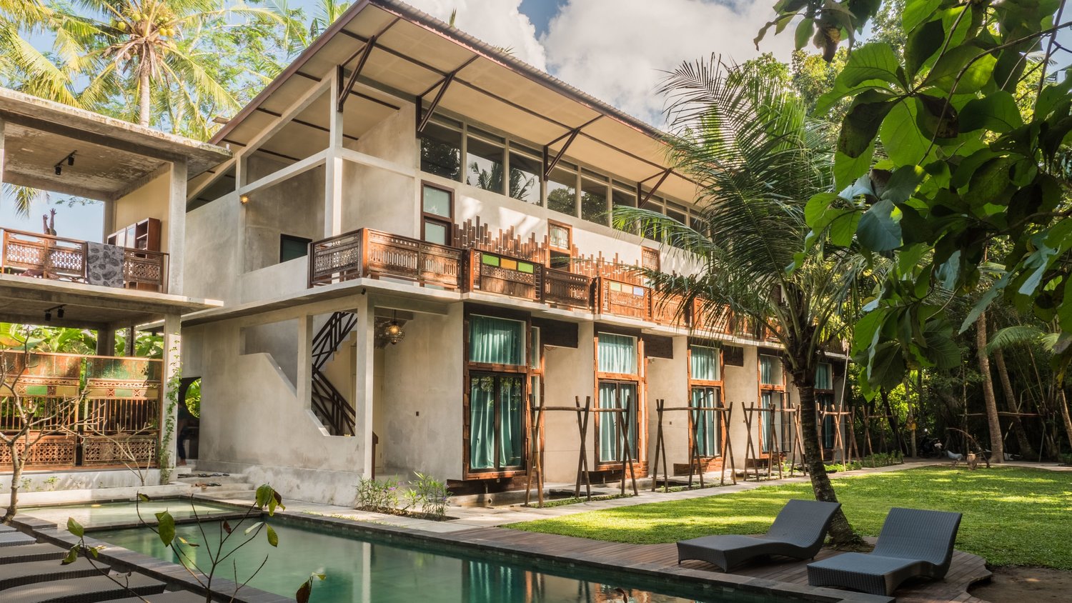A Pangea retreat center nestled among palms with a quiet pool